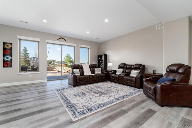 living area featuring light wood-type flooring, recessed lighting, and baseboards