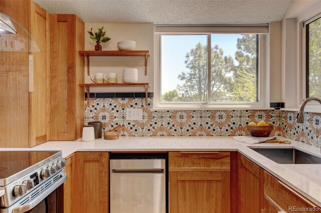 11358 W 85th Pl Unit E, Arvada, CO 80005 - kitchen with a sink, tasteful backsplash, a textured ceiling, and light countertops