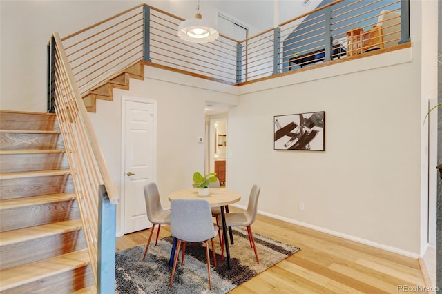 11358 W 85th Pl Unit E, Arvada, CO 80005 - dining area with stairway, wood finished floors, and baseboards