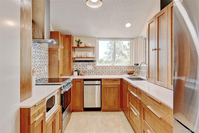 11358 W 85th Pl Unit E, Arvada, CO 80005 - kitchen featuring stainless steel appliances, wall chimney range hood, a sink, decorative backsplash, and light countertops