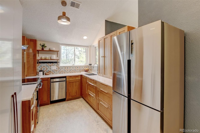 11358 W 85th Pl Unit E, Arvada, CO 80005 - kitchen with stainless steel appliances, a sink, light countertops, a textured ceiling, and open shelves