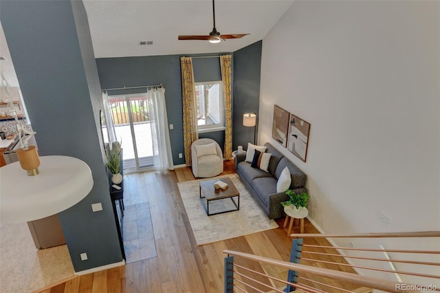 11358 W 85th Pl Unit E, Arvada, CO 80005 - living area with vaulted ceiling, wood finished floors, ceiling fan, and baseboards