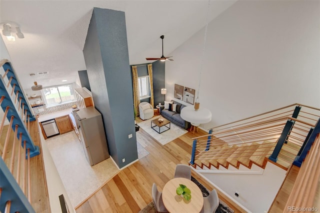 11358 W 85th Pl Unit E, Arvada, CO 80005 - staircase with wood finished floors, a ceiling fan, high vaulted ceiling, and baseboards