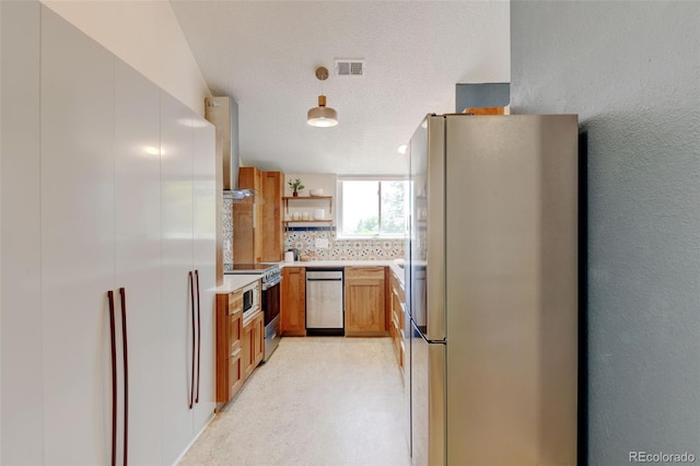 11358 W 85th Pl Unit E, Arvada, CO 80005 - kitchen featuring appliances with stainless steel finishes, open shelves, light countertops, wall chimney range hood, and backsplash