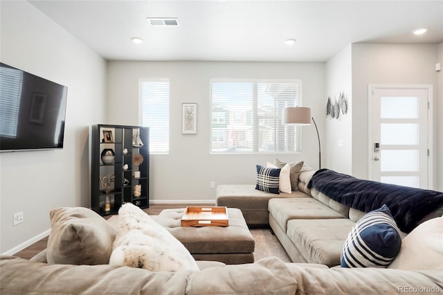 living room with light wood-style floors, recessed lighting, visible vents, and baseboards