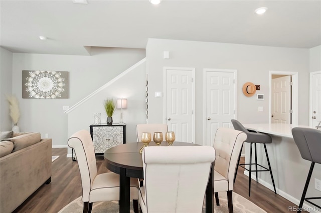 dining space featuring dark wood-type flooring, recessed lighting, and baseboards