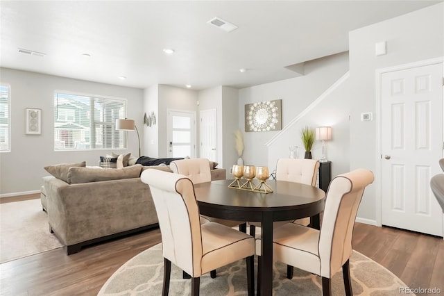 dining space with recessed lighting, visible vents, baseboards, and wood finished floors