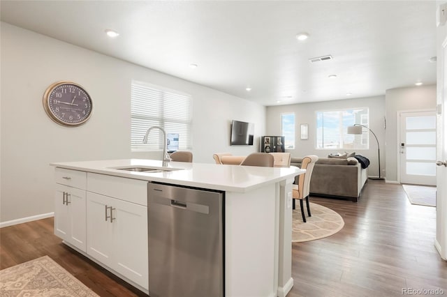 kitchen featuring a center island with sink, white cabinets, dishwasher, open floor plan, and a sink