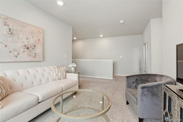 living room featuring recessed lighting, light colored carpet, and baseboards