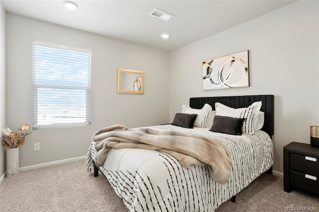 carpeted bedroom featuring recessed lighting, visible vents, and baseboards