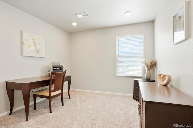 office area with light carpet, visible vents, and baseboards