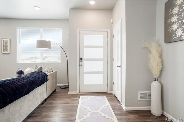 foyer with baseboards, recessed lighting, visible vents, and wood finished floors