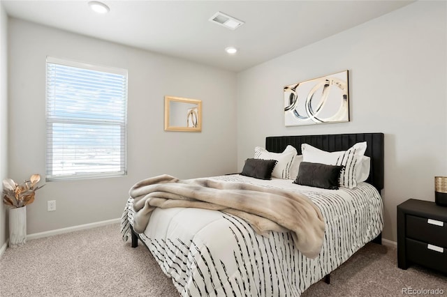 carpeted bedroom with multiple windows, baseboards, and recessed lighting