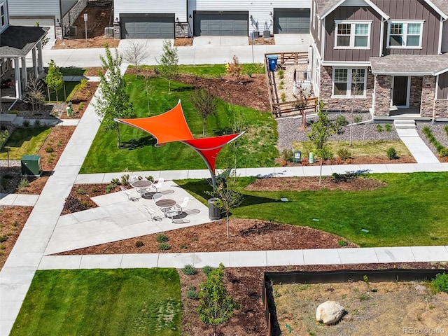 view of yard featuring concrete driveway and a garage
