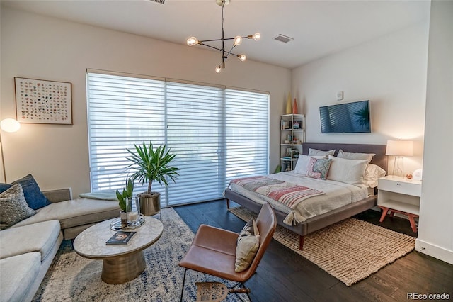 bedroom featuring dark wood-style flooring, multiple windows, and visible vents