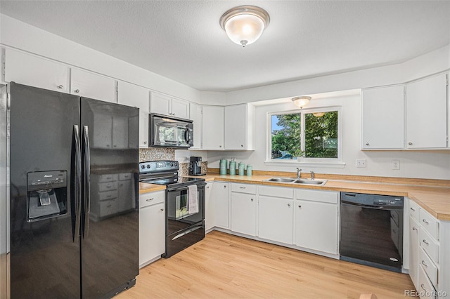 1641 Biscay Cir, Aurora, CO 80011 - kitchen featuring black appliances, light wood-style flooring, and white cabinets