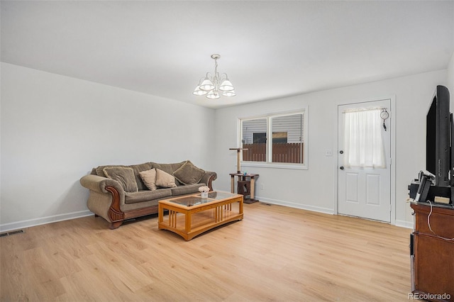 1641 Biscay Cir, Aurora, CO 80011 - living area featuring light wood-type flooring, a chandelier, and plenty of natural light
