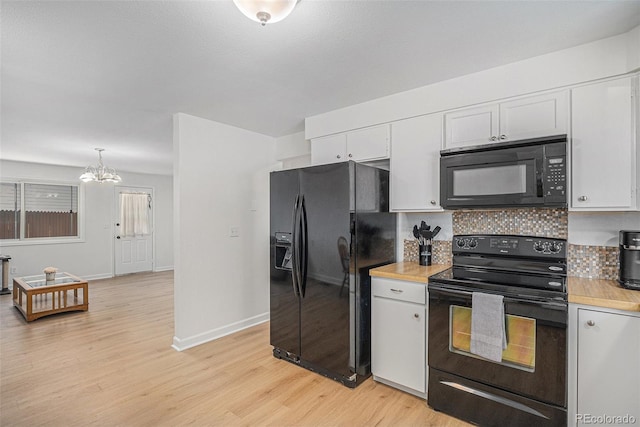 1641 Biscay Cir, Aurora, CO 80011 - kitchen featuring black appliances, a chandelier, light wood finished floors, light countertops, and white cabinetry