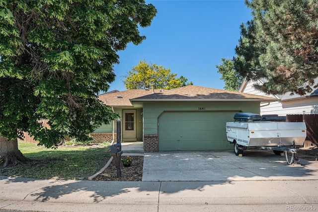 1641 Biscay Cir, Aurora, CO 80011 - view of front of house with a garage, brick siding, and driveway