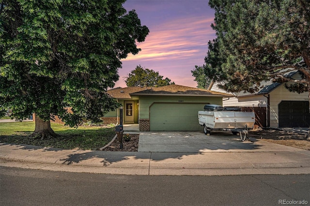 1641 Biscay Cir, Aurora, CO 80011 - view of front of house with a garage, brick siding, and driveway