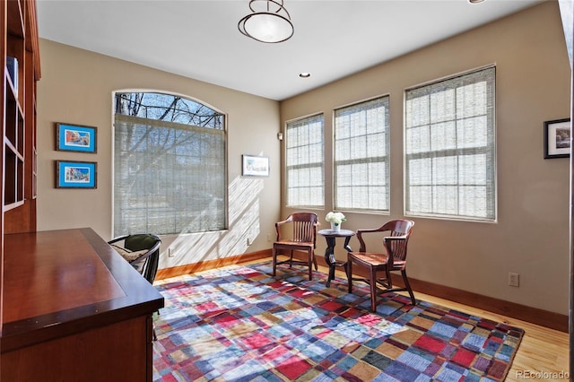 living area with wood finished floors and baseboards