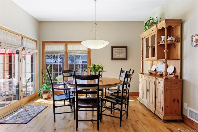 dining space featuring visible vents, baseboards, and light wood-style floors