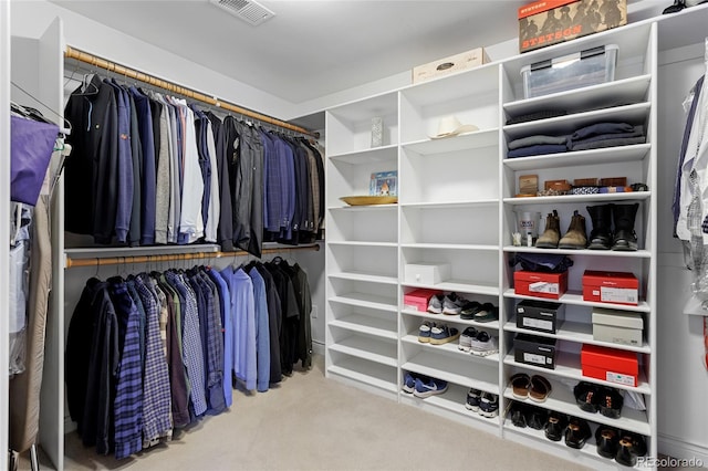 walk in closet featuring visible vents and carpet