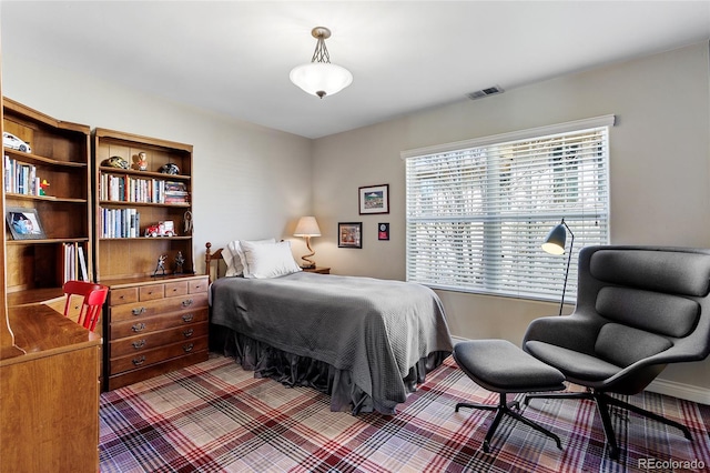 carpeted bedroom featuring visible vents