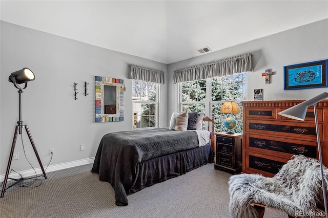 carpeted bedroom with visible vents and baseboards