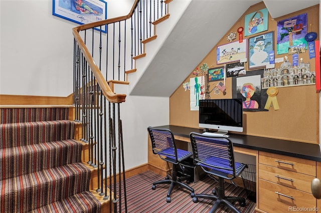 office featuring built in desk, baseboards, and vaulted ceiling