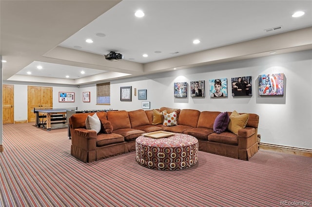 living area featuring carpet, visible vents, baseboards, a tray ceiling, and recessed lighting