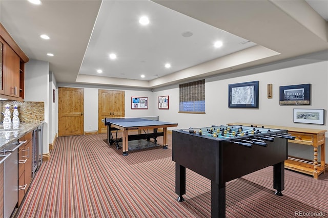 playroom featuring recessed lighting, a tray ceiling, carpet, and beverage cooler