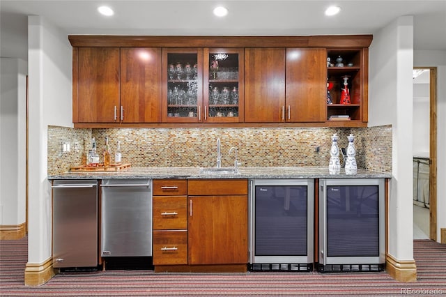 bar with a sink, indoor wet bar, wine cooler, and tasteful backsplash