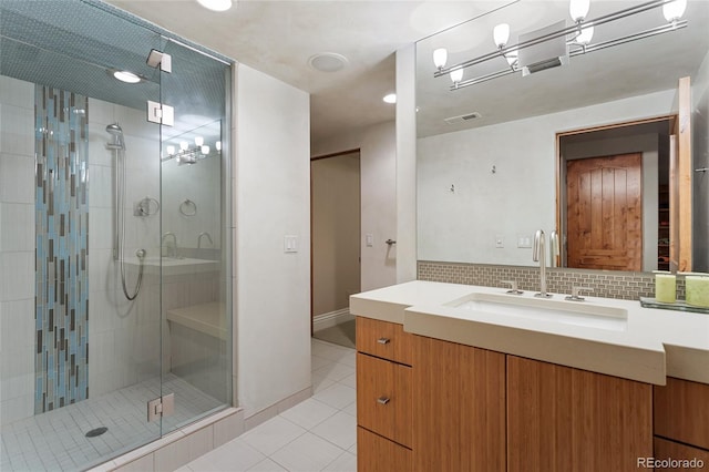 bathroom featuring tile patterned flooring, visible vents, tasteful backsplash, a stall shower, and vanity