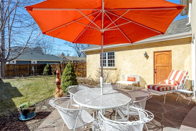 view of patio / terrace featuring outdoor dining area and fence