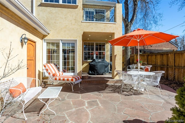 view of patio / terrace featuring outdoor dining space, a grill, and fence