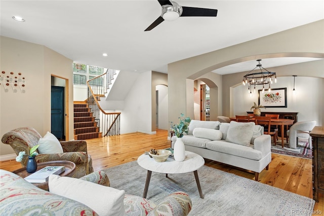 2411 S Milwaukee St, Denver, CO 80210 - living area with arched walkways, light wood-type flooring, stairs, a ceiling fan, and recessed lighting
