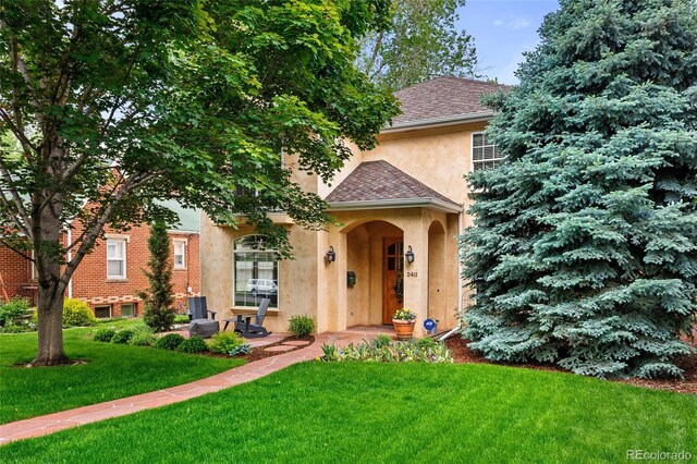 2411 S Milwaukee St, Denver, CO 80210 - view of front of house with stucco siding, a front yard, and roof with shingles