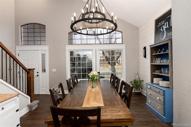 dining room with a notable chandelier, stairway, high vaulted ceiling, and dark wood-style flooring