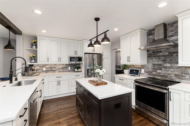 kitchen with open shelves, a sink, stainless steel appliances, white cabinetry, and wall chimney exhaust hood