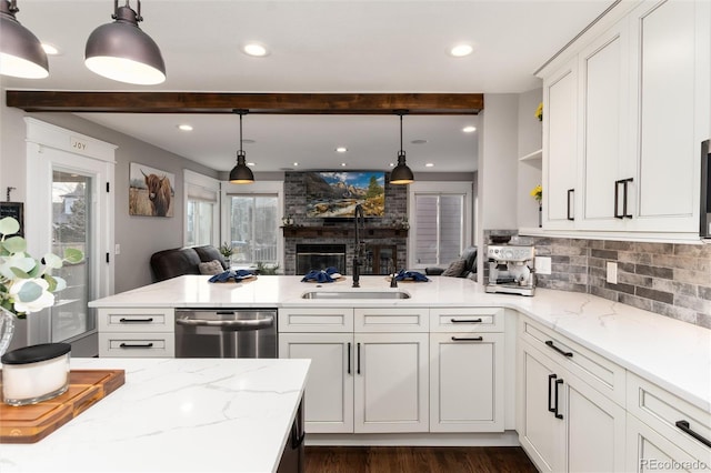 kitchen with open floor plan, dishwasher, a peninsula, white cabinetry, and open shelves