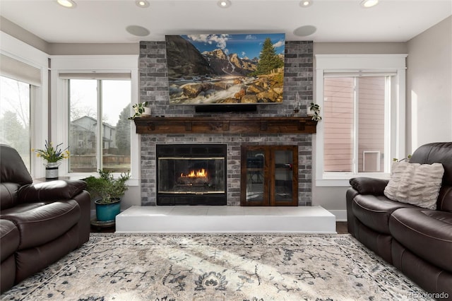 living area with recessed lighting and a brick fireplace