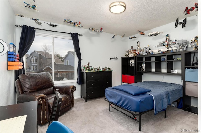 bedroom with carpet floors and a textured ceiling