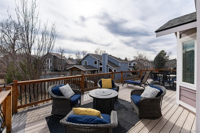 deck with outdoor dining area and a residential view