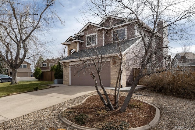 view of front facade with an attached garage, brick siding, and driveway