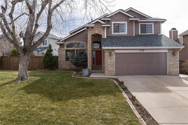 view of front of house with a front lawn, fence, concrete driveway, a garage, and brick siding