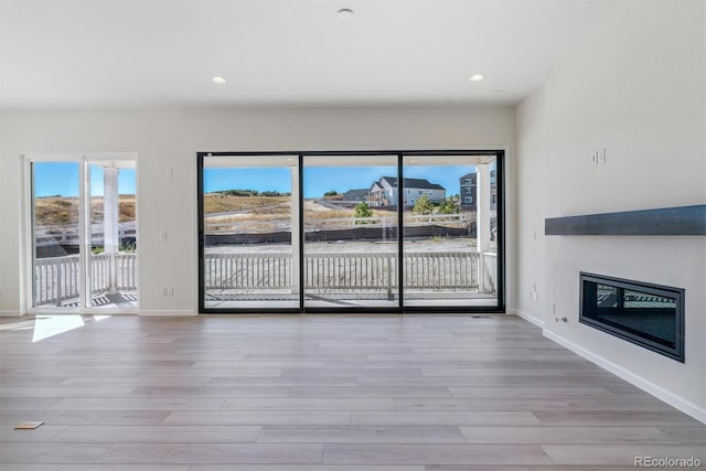 unfurnished living room featuring light wood-type flooring