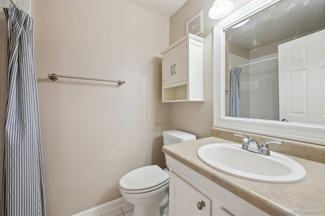 bathroom featuring a shower with shower curtain, vanity, toilet, and tile patterned floors