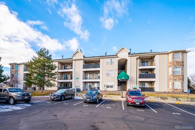 view of building exterior with uncovered parking