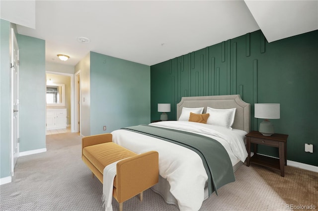 bedroom with light carpet and baseboards